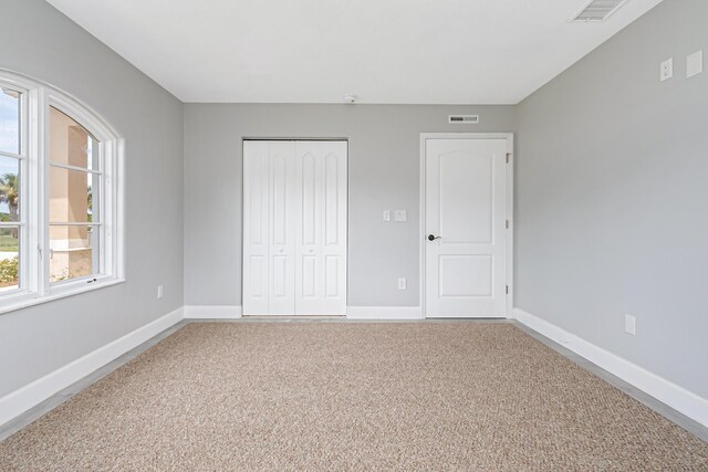 unfurnished bedroom featuring a closet and carpet floors