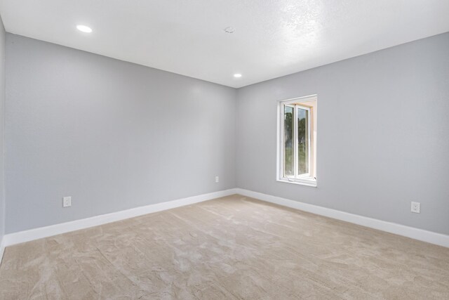 unfurnished room featuring carpet