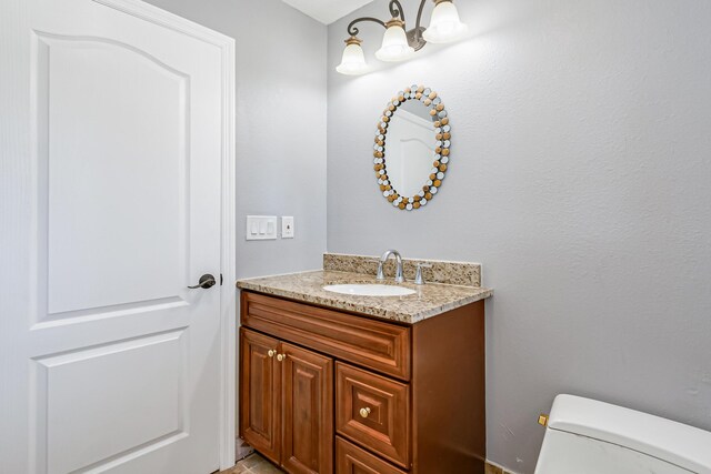 bathroom featuring toilet and vanity