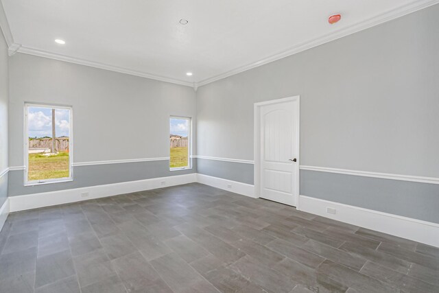 tiled spare room with crown molding