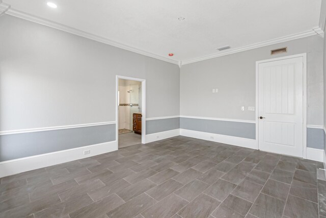 empty room featuring ornamental molding and tile patterned flooring