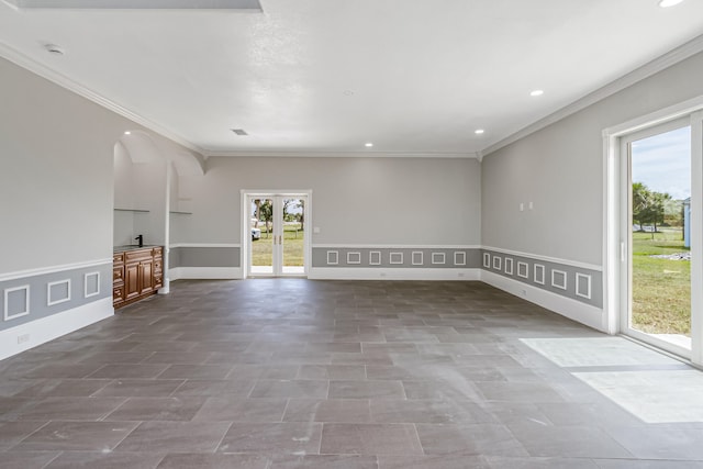 unfurnished living room with tile patterned flooring, french doors, and ornamental molding