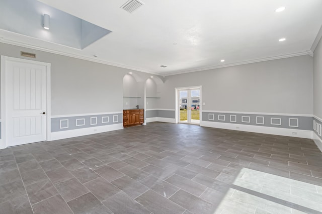 unfurnished living room with tile patterned floors and crown molding