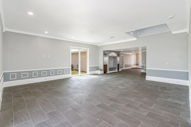 unfurnished living room with decorative columns and crown molding