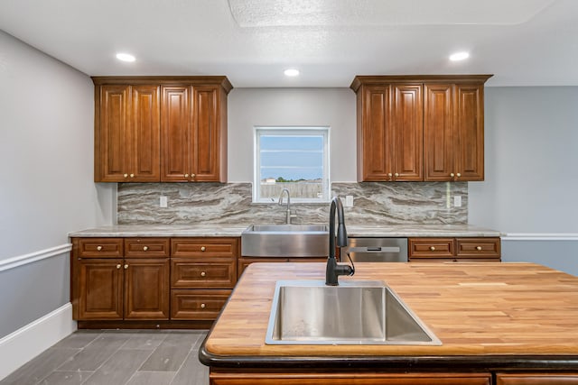 kitchen with wooden counters, sink, and decorative backsplash