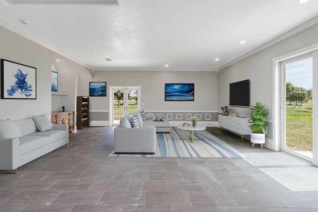 living room featuring tile patterned flooring, crown molding, and french doors