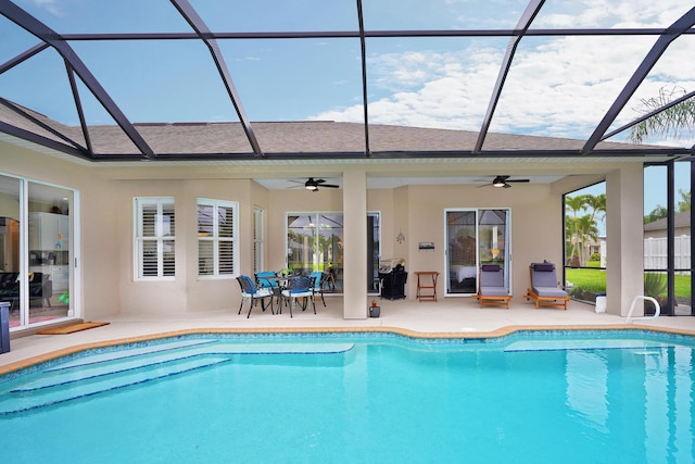 view of pool with a lanai, a patio area, and ceiling fan