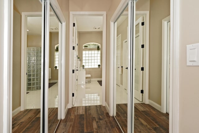 corridor with dark hardwood / wood-style flooring