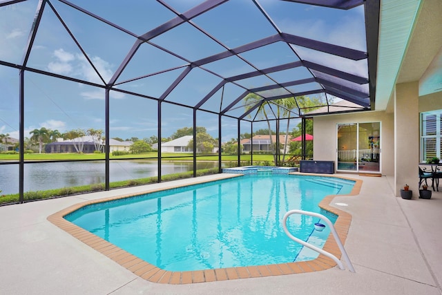 view of swimming pool featuring glass enclosure, a patio area, and a water view