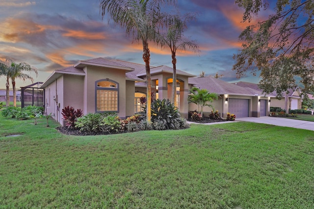 mediterranean / spanish home with a lawn, a lanai, and a garage