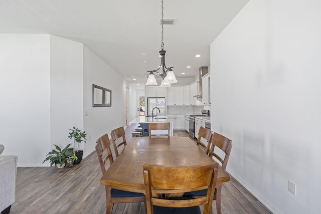 dining space featuring hardwood / wood-style floors and sink