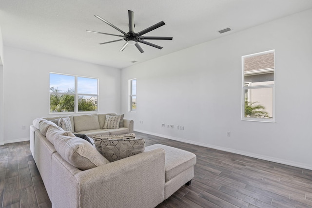 living room with ceiling fan and dark hardwood / wood-style floors