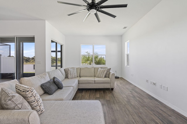 living room with dark hardwood / wood-style floors and ceiling fan