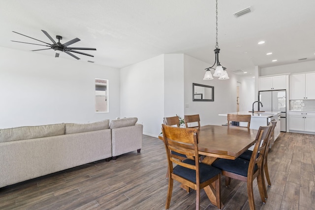 dining area with dark hardwood / wood-style floors, ceiling fan, and sink