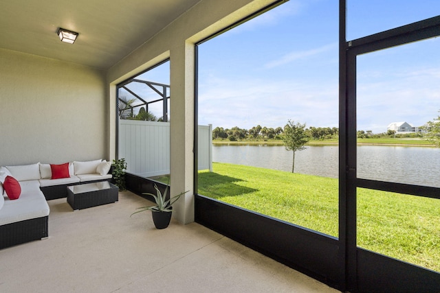 sunroom featuring a water view