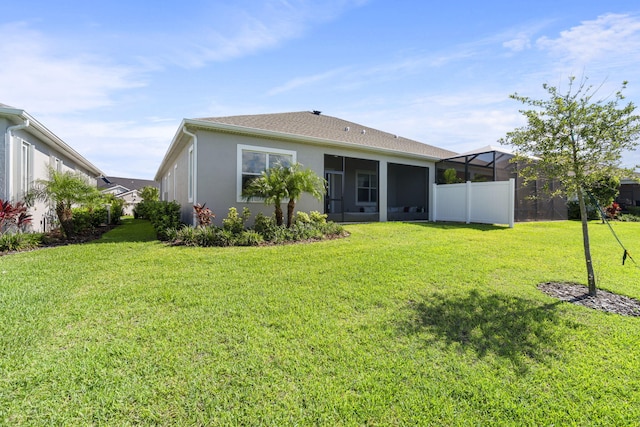 rear view of property featuring a yard