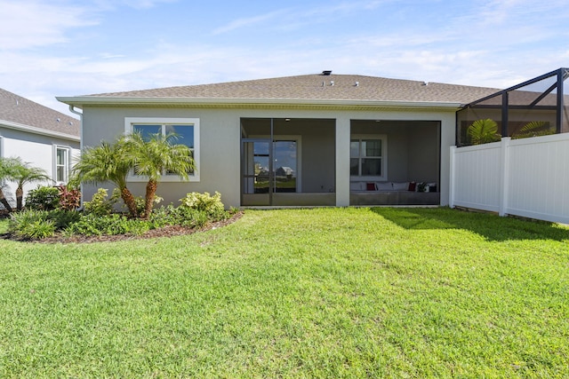 back of property featuring a yard and a lanai