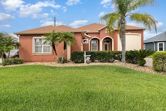 view of front facade with a front lawn and a garage