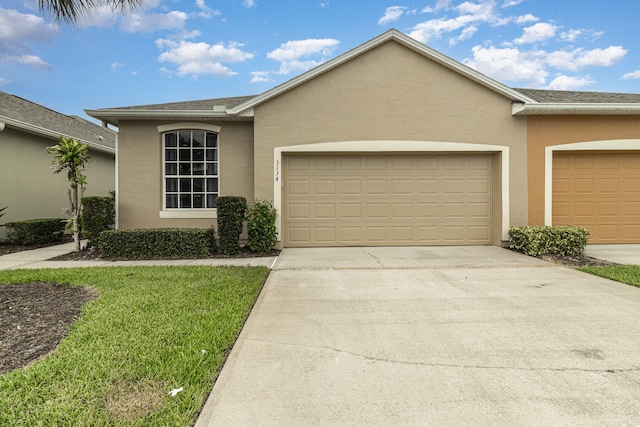 ranch-style home with a front yard and a garage