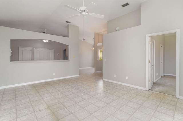 tiled empty room featuring high vaulted ceiling and ceiling fan