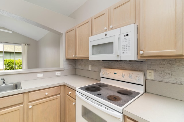 kitchen with lofted ceiling, white appliances, backsplash, sink, and light brown cabinetry