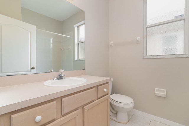 bathroom featuring tile flooring, toilet, and vanity