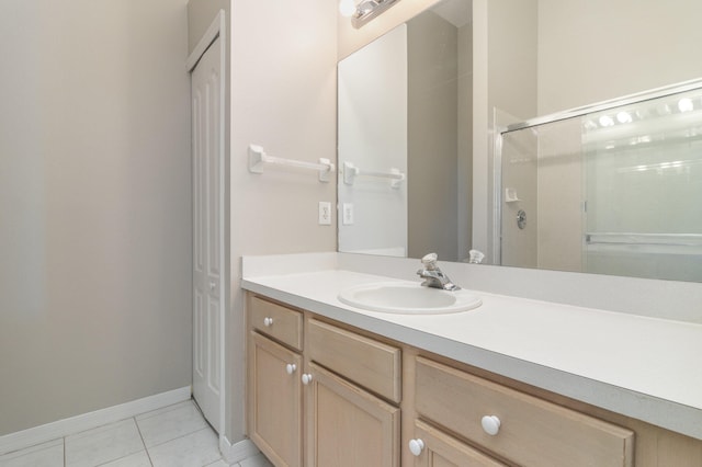 bathroom featuring a shower with shower door, oversized vanity, and tile floors