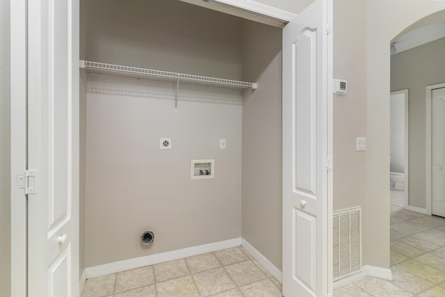 washroom with electric dryer hookup, washer hookup, and light tile flooring