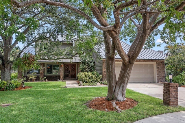 view of front facade with french doors, a front yard, and a garage