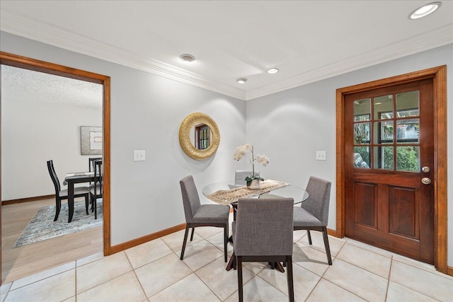 tiled dining room with ornamental molding