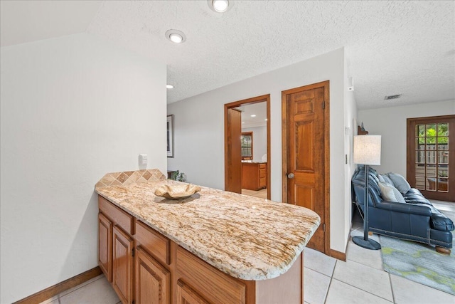 bathroom featuring tile patterned flooring and a textured ceiling