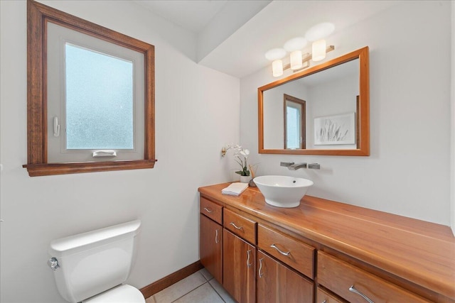 bathroom with tile patterned flooring, vanity, and toilet