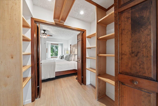 interior space featuring light wood-type flooring and a textured ceiling