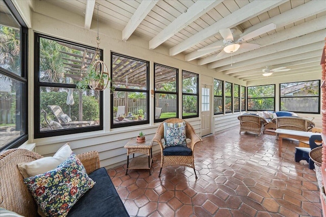 sunroom featuring beamed ceiling, a healthy amount of sunlight, and wood ceiling