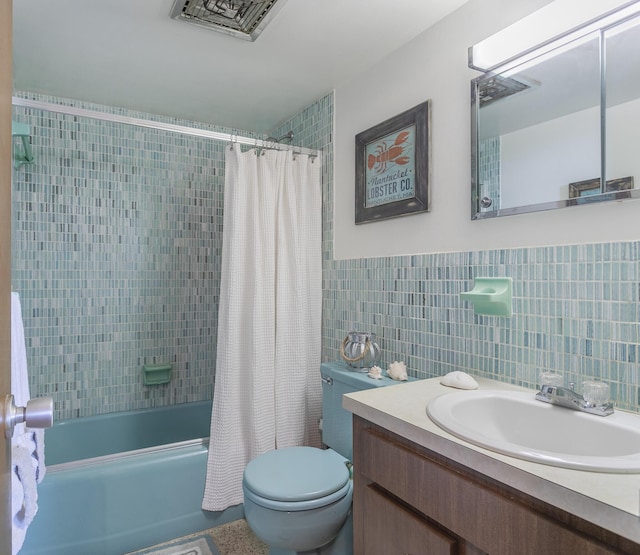 full bathroom with shower / bath combination with curtain, vanity, toilet, and tile walls