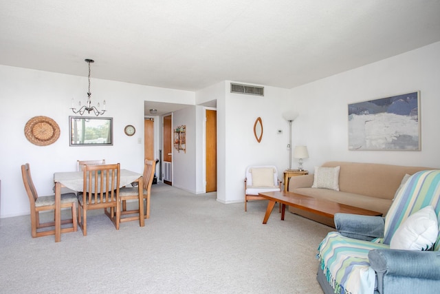 carpeted living room featuring a notable chandelier