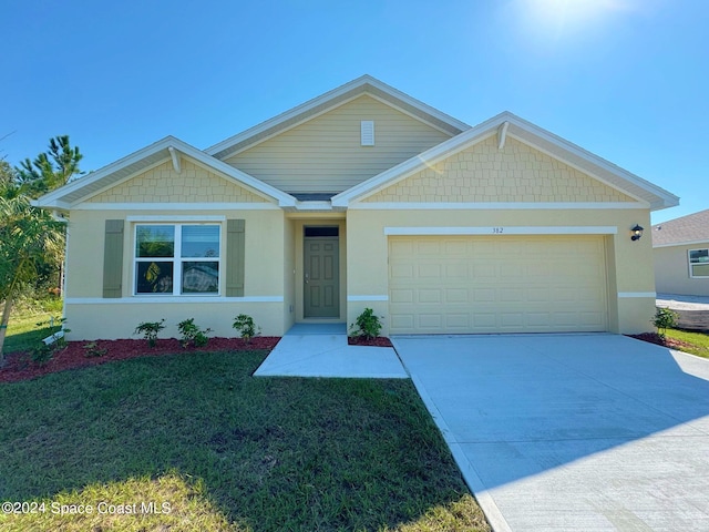 view of front of property with a garage and a front yard