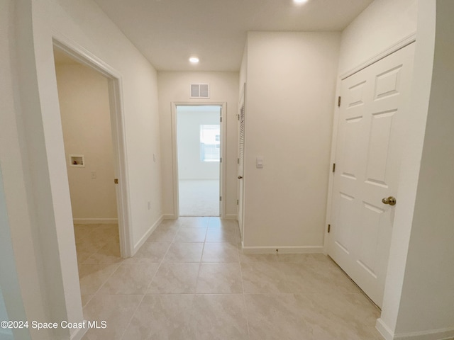 corridor with light tile patterned floors