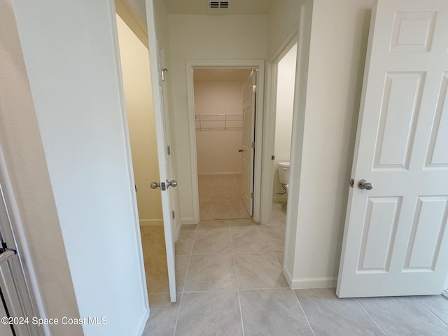 hallway featuring light tile patterned floors