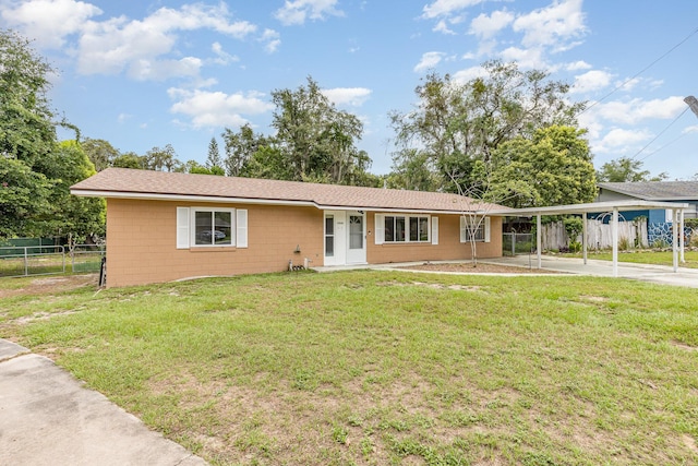 ranch-style house with a carport and a front yard