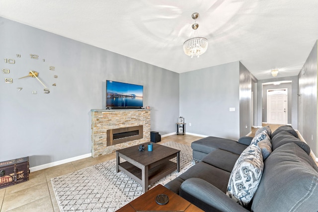 living room with a stone fireplace, an inviting chandelier, a textured ceiling, and light tile patterned floors