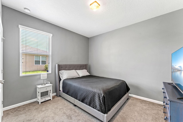 carpeted bedroom featuring a textured ceiling