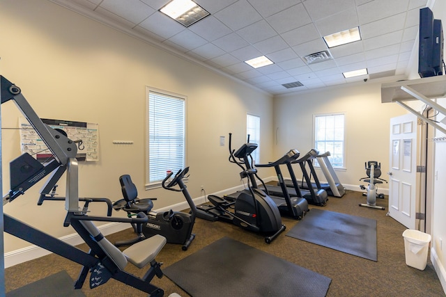 gym featuring crown molding and a paneled ceiling