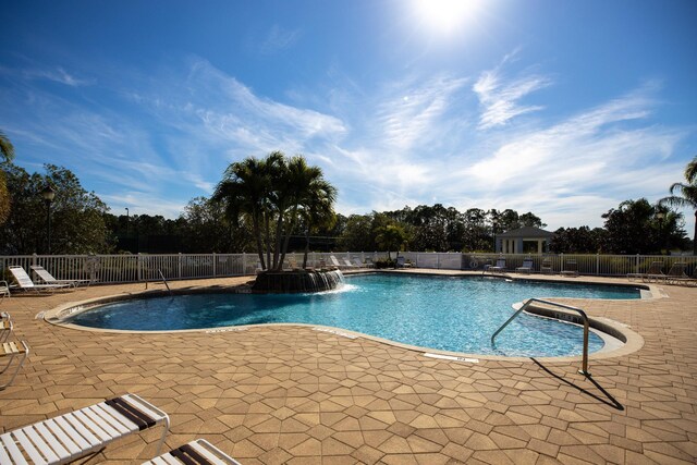 view of swimming pool with a patio and pool water feature