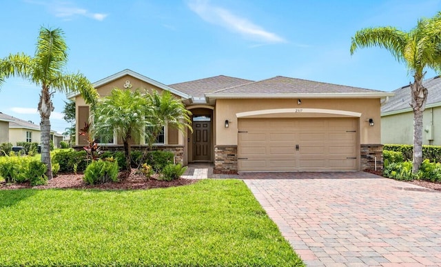 view of front of home featuring a front yard and a garage