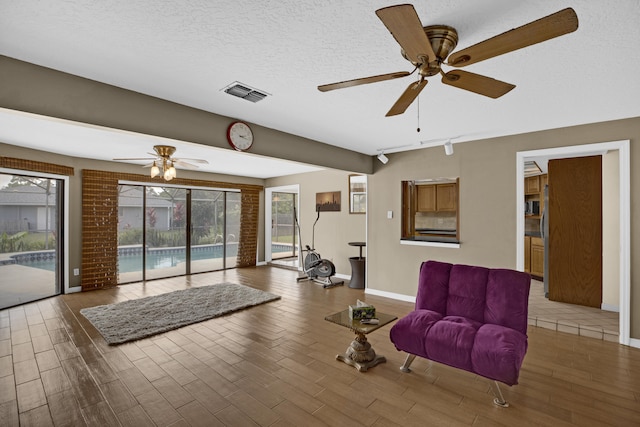 living area with dark wood-type flooring and a textured ceiling