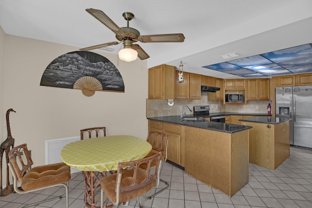 kitchen featuring sink, exhaust hood, a center island, appliances with stainless steel finishes, and backsplash