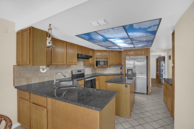 kitchen with sink, dark stone countertops, stainless steel appliances, a center island, and ventilation hood