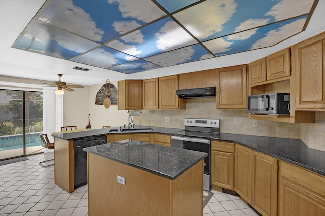 kitchen with light tile patterned floors, sink, a center island, tasteful backsplash, and black appliances