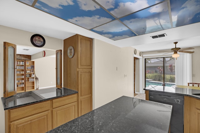 kitchen featuring ceiling fan, dark stone counters, and dishwasher